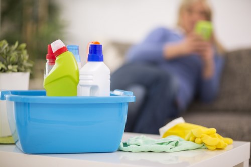 Staff member using protective gloves and mask during cleaning